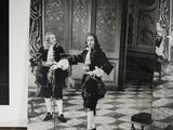 a black and white photo of two children in a room