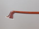 a close up of a wooden axe with a metal handle