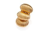 an image of a stack of gold rings on a white surface