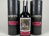 two bottles of devil wine sitting next to each other on a table