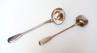two spoons that are sitting on a table