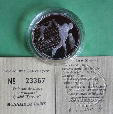 a silver coin with a picture of a baseball player on it