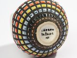 a black and white vase with a colorful design on it