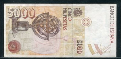 une image représentant un gros plan d'un billet de banque sur lequel figure un globe terrestre