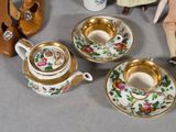 three tea cups and saucers on a table