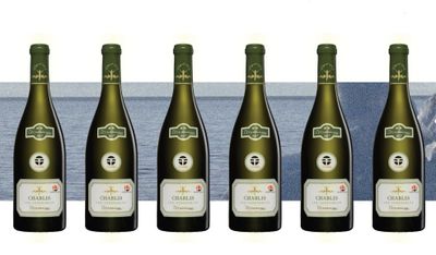 six bottles of wine are lined up on a table