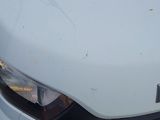 a close up of the front of a car with a denting headlight