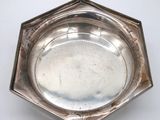 an antique silver plate on a white table with a white background