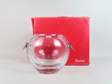 a small glass vase with a red box in the background