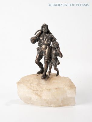 a statue of a man holding a child on a rock