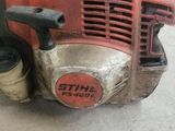 a small red machine that is sitting on the floor