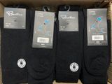 three pairs of men ' s black socks in a cardboard box
