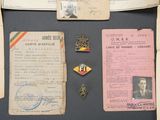 a lot of old papers and badges on a table