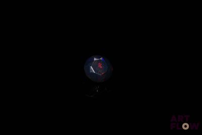 an image of a blue and red fire opal in the dark