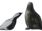 pair of black and white sculptures of a seal and a penguin