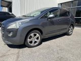 the grey car is parked in front of a building