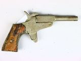an old toy gun with a wooden handle on a white surface