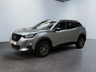 a silver suv parked in a large room with a ceiling fan