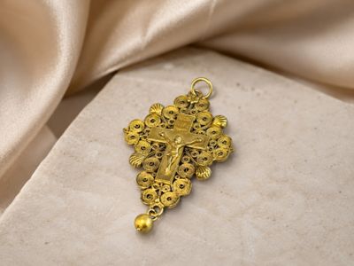 gold plated crucift with a cross and a pearl bead