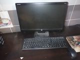 a computer monitor and a keyboard on a desk
