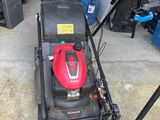 an image of a lawn mower parked in a garage
