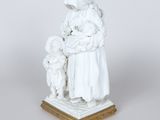 an image of a statue of a woman holding a baby and a child
