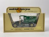 a green toy truck in a cardboard box