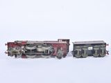two toy trains sitting side by side on a white surface