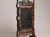 a mirror that is on a stand with a mirror on it