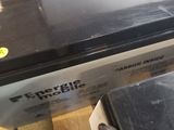 a black oven sitting on top of a wooden table