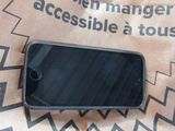 a cell phone sitting on top of a brown paper bag