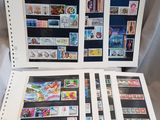 two pages of stamps are sitting on top of each other on a table