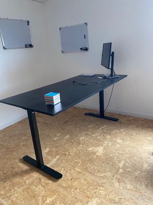 a desk with a computer on it in a room