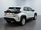 the rear end of a white toyota rav parked in a room