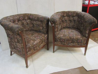 two chairs sitting next to each other on a rug
