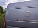a silver van that is parked in the grass