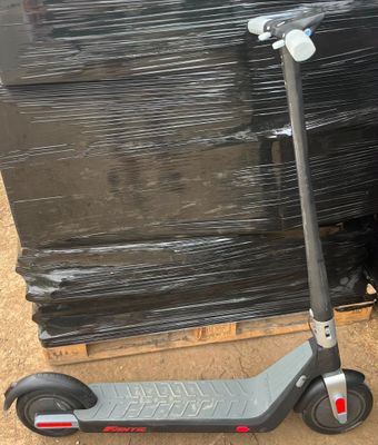 a scooter that is sitting on a pallet next to a pile of pallets