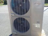 an air conditioner sitting on top of a pallet in a parking lot