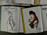 a lot of books with drawings on them on a table