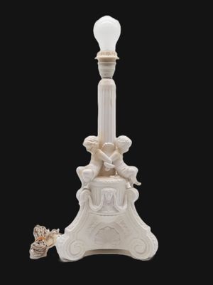 an image of a lamp post with a statue on top of it