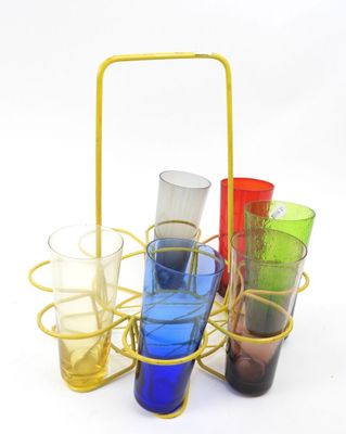 four glasses in a basket on a white surface