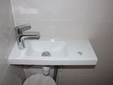 a white sink and a toilet in a small bathroom