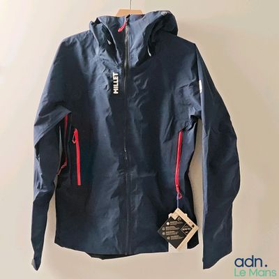 the jacket is blue and has red zippers on the sleeves