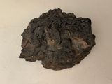 a rock that is sitting on a white surface