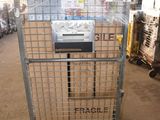 a large metal cart with boxes on it in a warehouse