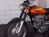 a motorcycle parked in a garage with a brick wall in the background