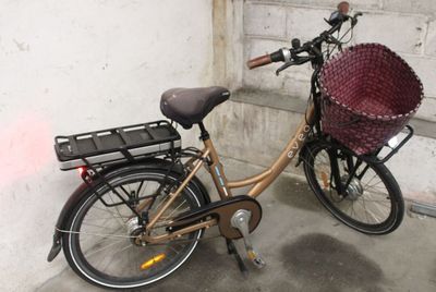 a bicycle with a basket attached to the back of it