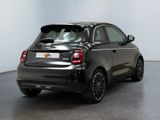 the back of a small black car is parked in a room