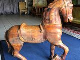 un cheval de bois posé sur un tapis bleu