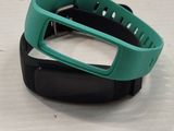 a green and black wristband with a black band